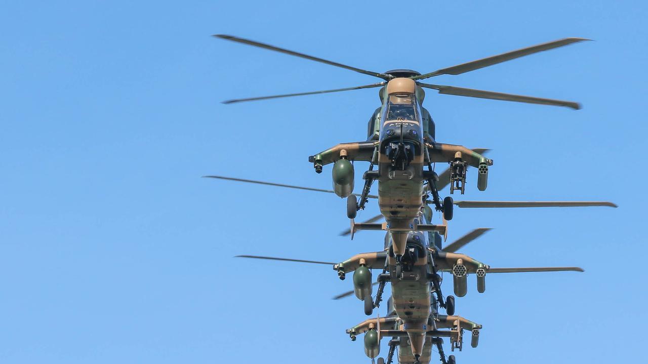 Attack Helicopters conduct a flypast during the march on Darwin's Knuckey St commemorating ANZAC Day 2021. Picture Glenn Campbell