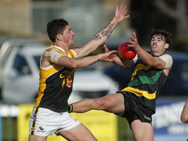 Frankston YCW’s BJ Credlin tries to spoil Dromana’s Reece Wilde. Picture: Valeriu Campan