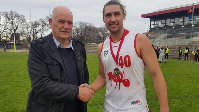 Harold Martin congratulates best-on-ground Daniel Hughes. Picture: Ben Higgins