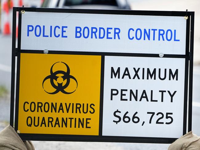 Border control signage is seen as motorists approach the Queensland - New South Wales border at Currumbin on Gold Coast, Thursday, April 2, 2020. From 3 April, Queensland borders will be tightened further, closed to everyone except residents and essential workers, including freight carriers and emergency workers.  (AAP Image/Dave Hunt) NO ARCHIVING