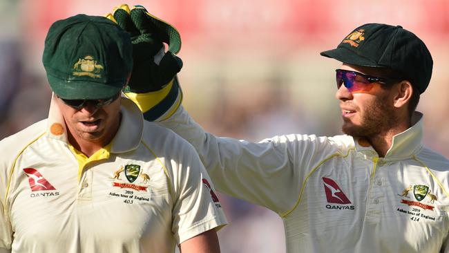 Australia's captain Tim Paine (R) talks to Peter Siddle during last year’s Ashes series. Paine and Siddle will now be state teammates (Photo by Glyn KIRK / AFP)