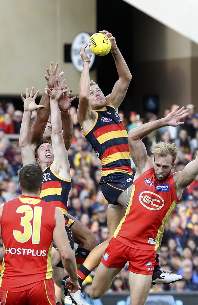 Hugh Greenwood takes a big grab over Gold Coast’s Jack Hombsch. Picture SARAH REED