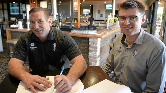 NEW ERA: Gavin Pitts and Beau Dabron look over the plans for the expansion of the Gracemere Hotel which will include a motel, function room and additional parking. Picture: Chris Ison ROK220518cgracemere1