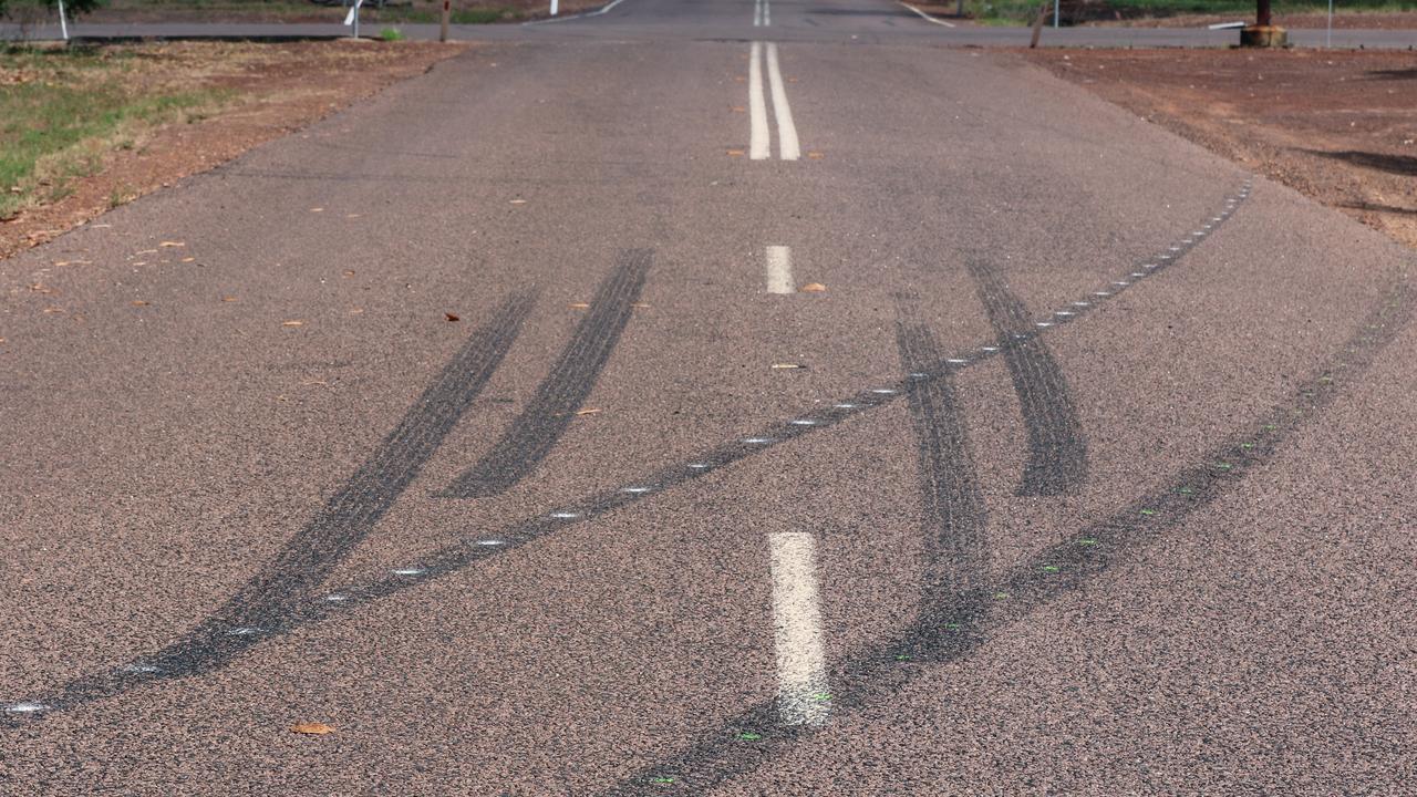 Floral tributes and recent burnouts mark the scene of the weekends fatal at Bees Creek. Picture: Glenn Campbell