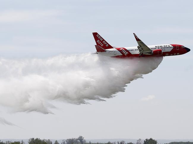 The RFS Marie Bashir 737 Large Air Tanker drops water during a demonstration flight at RAAF Base Richmond in 2020.