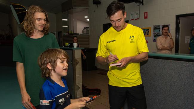 Nick Timmings signing cards for Carman Strachan and Jay Strachan as Olympians run training drills with Katherine kids at the YMCA as part of Olympics Unleashed program. Picture: Pema Tamang Pakhrin