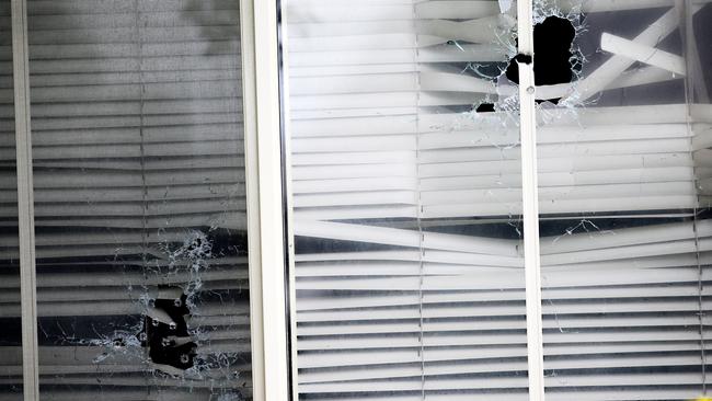 Bullet holes in the lounge room window of a home which was targeted in a drive-by shooting. Picture Stephen Cooper