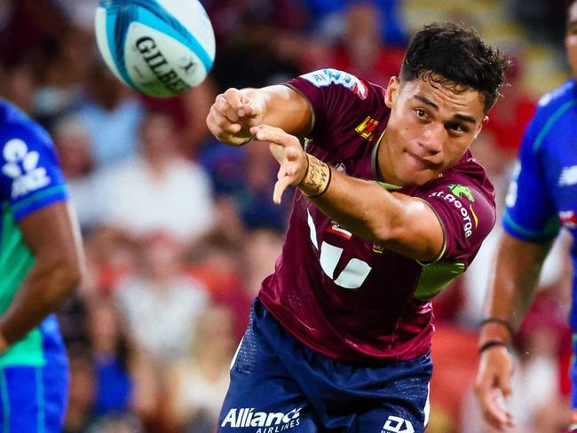 Queensland Red's Kalani Thomas makes a pass during the Super Rugby match between the Queensland Reds and Fijian Drua at Suncorp Stadium in Brisbane on March 12, 2022. (Photo by Patrick HAMILTON / AFP) / -- IMAGE RESTRICTED TO EDITORIAL USE - STRICTLY NO COMMERCIAL USE --