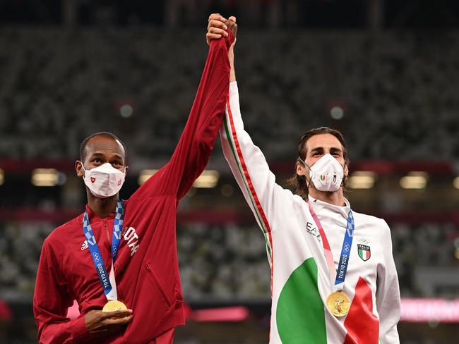 Joint gold medallists Qatar's Mutaz Essa Barshim (R) and Italy's Gianmarco Tamberi pose on the podium of the men's high jump final. Picture: AFP