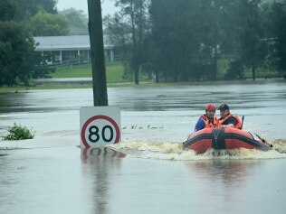 An SES boat patrols the flooded waterways of the Hawkesbury River at Vineyard on Thursday. Picture: Jeremy Piper