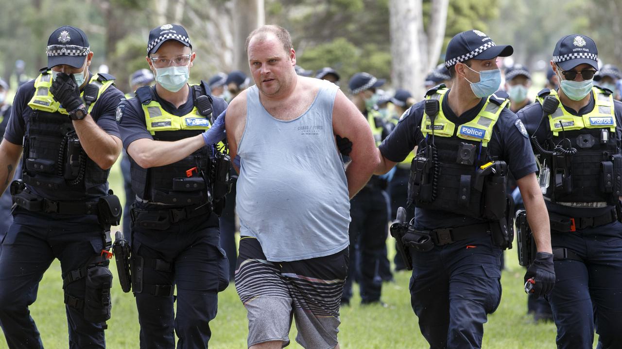 Police arrest a man at an anti-vax protest in Fawkner Park in Melbourne. Picture: NCA NewsWire/David Geraghty