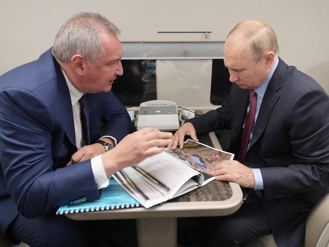 Russian President Vladimir Putin (R) speaks with head of Russia's space agency Roscosmos Dmitry Rogozin. Picture: AFP