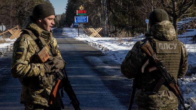 Members of the Ukrainian State Border Guard stand watch at the border crossing between Ukraine and Belarus – where Russian forces are conducting large-scale military exercises – on Sunday. Picture: Chris McGrath/Getty Images