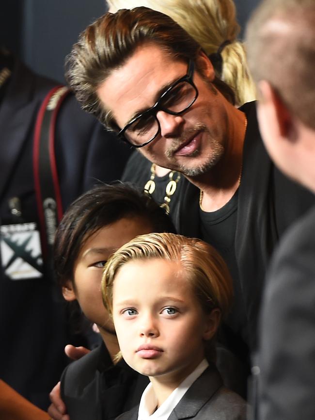 Shilo Jolie — pictured with dad Brad Pitt in 2014 — preferred suits and T-shirts from early childhood. Picture: Robyn Beck