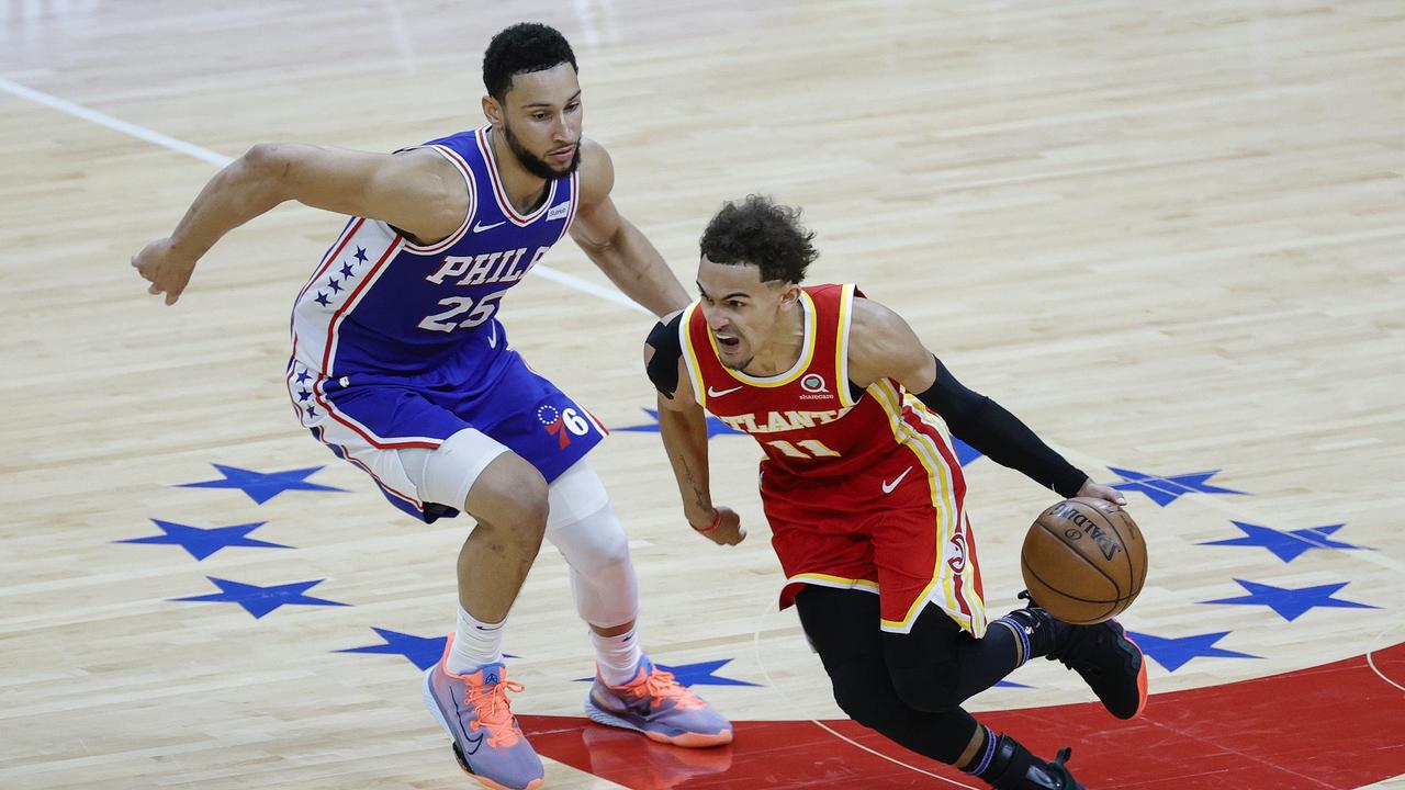 PHILADELPHIA, PENNSYLVANIA - JUNE 16: Trae Young #11 of the Atlanta Hawks dribbles past Ben Simmons #25 of the Philadelphia 76ers during the fourth quarter during Game Five of the Eastern Conference Semifinals at Wells Fargo Center on June 16, 2021 in Philadelphia, Pennsylvania. NOTE TO USER: User expressly acknowledges and agrees that, by downloading and or using this photograph, User is consenting to the terms and conditions of the Getty Images License Agreement. Tim Nwachukwu/Getty Images/AFP == FOR NEWSPAPERS, INTERNET, TELCOS &amp; TELEVISION USE ONLY ==