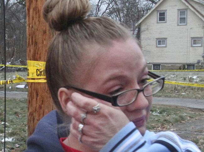 Melissa Thomas, right, wipes away a tear as her daughter Elissa Simione looks on near the scene of a deadly fire in Youngstown, Ohio, Monday, Dec. 10, 2018. Authorities report that several children died in the fire. (William D. Lewis/The Vindicator via AP)