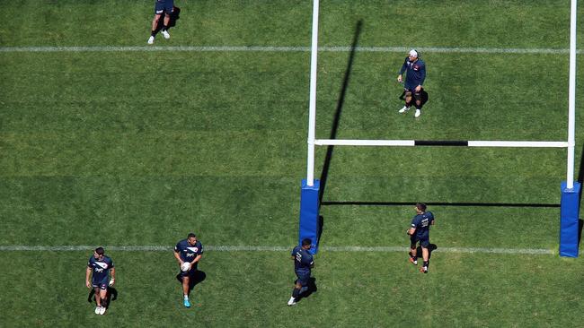 Cronk (top in white hat) watches his teammates train. Picture: Sam Ruttyn