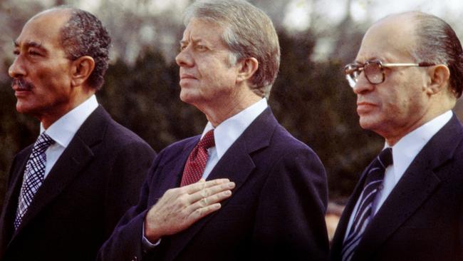 Then Egyptian president Anwar al-Sadat, Jimmy Carter and Israeli premier Menachem Begin listen to the national anthem before signing the Egypt-Israel Peace Treaty on the north lawn of the White House in 1979. Picture: David Hume Kennerly/Getty Images