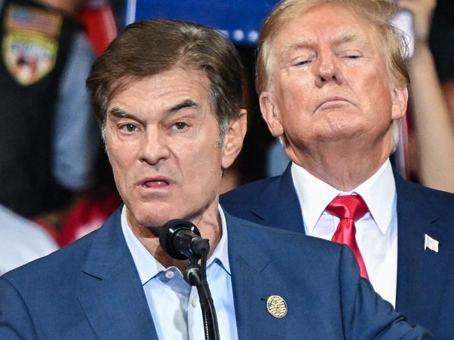 (FILES) Mehmet Oz, who is running for the US Senate, speaks as former US President Donald Trump stands behind him during a campaign rally in support of Oz and Doug Mastriano for Governor of Pennsylvania at Mohegan Sun Arena in Wilkes-Barre, Pennsylvania on September 3, 2022. President-elect Donald Trump on November 19, announced the nomination of Dr. Mehmet Oz to serve as the Centers for Medicare and Medicaid Services (CMS) Administrator. (Photo by Ed JONES / AFP)