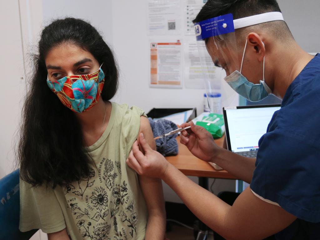 Enrolled nurse John Maya administers the Pfizer vaccine to a client in Sydney. Picture: Lisa Maree Williams/Getty Images