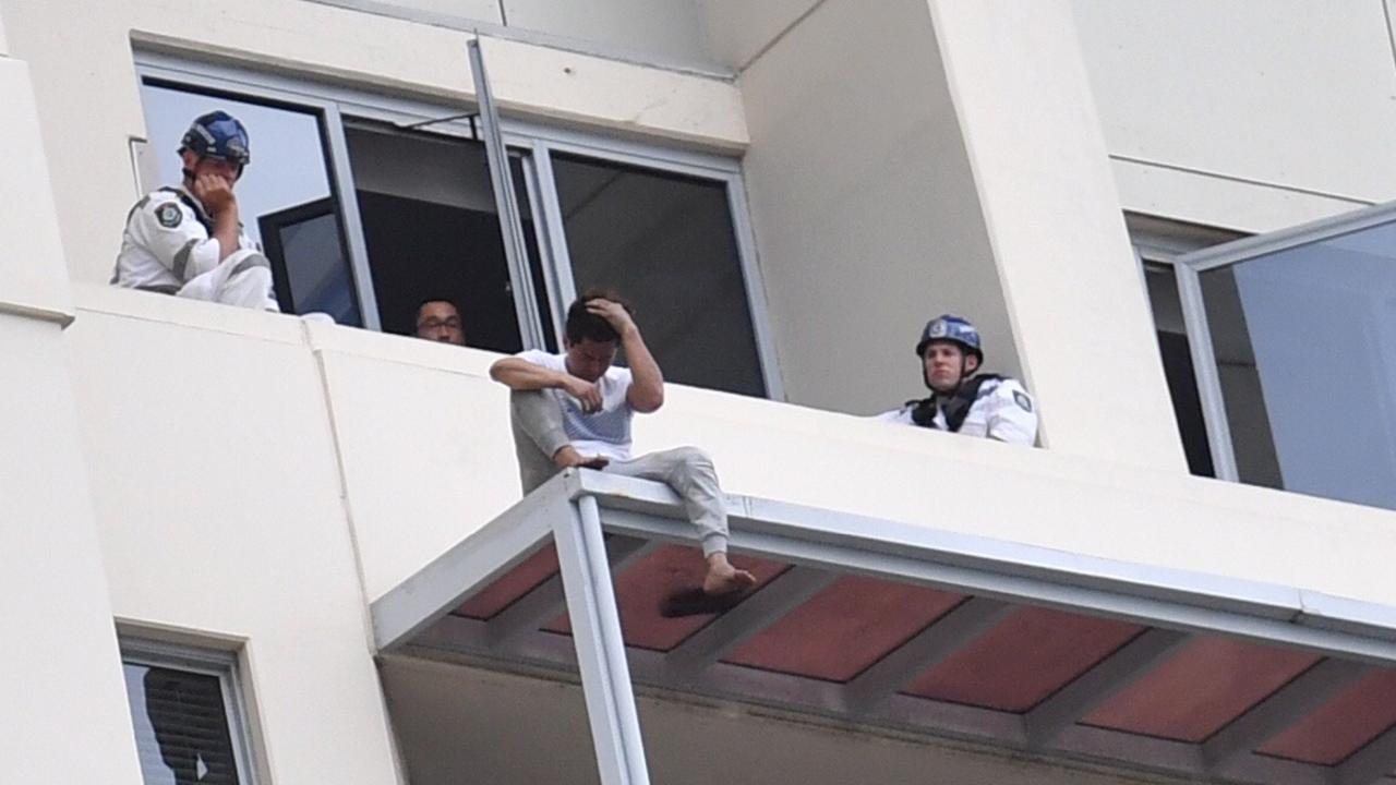 June Oh Seo on the ledge of the Chatswood apartment after pushing his girlfriend to her death. Picture: AAP Image/Mick Tsikas