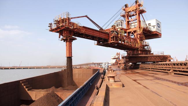 A conveyor belt loads up a barge at an iron ore transfer and storage centre operated by the Shanghai International Port Group in Shanghai in China. (Qilai Shen/Bloomberg)