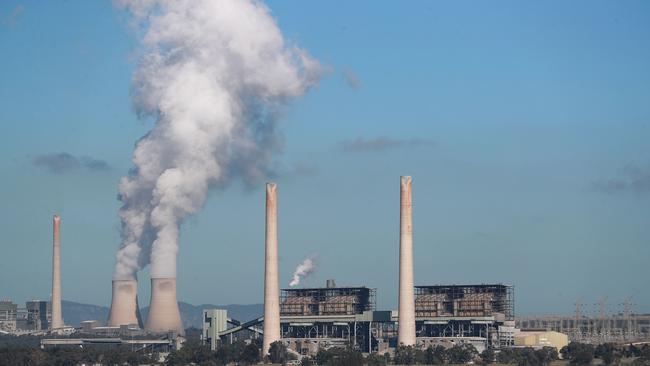 MUSWELLBROOK, AUSTRALIA - APRIL 27: Liddell Power Station stands next to Lake Liddell as chimneys at the Bayswater Power Station seen emit water vapour on April 27, 2023 in Muswellbrook, Australia. Liddell Power Station, one of Australia's oldest coal-fired power plants, will shut down on Friday, 28 April, after 52 years in operation. The AGL-owned facility opened in 1971 and was once the most powerful generating station in Australia. With Australia making the transition from coal power to renewables, the site will be transformed into a new low-carbon industrial energy hub. Demolition of the plant will begin next year, with more than 90 per cent of the materials to be recycled, AGL says. The closure of Liddell Power Station will stop 8 million tonnes of Carbon dioxide being released into the atmosphere every year, media reported. (Photo by Roni Bintang/Getty Images)