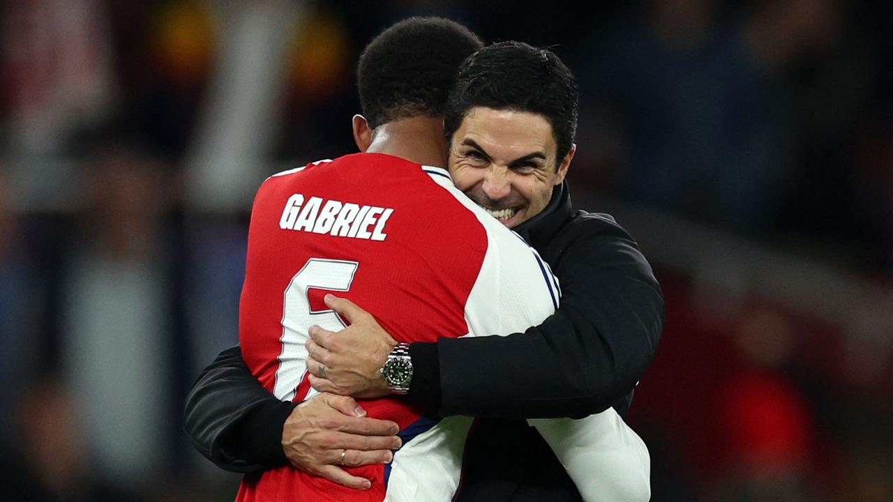 Arsenal's Spanish manager Mikel Arteta celebrates with Arsenal's Brazilian defender #06 Gabriel Magalhaes during the UEFA Champions League football match between Arsenal and Paris Saint-Germain (PSG) at the Emirates Stadium in north London on October 1, 2024. Arsenal won the match 2-0. (Photo by Adrian Dennis / AFP)