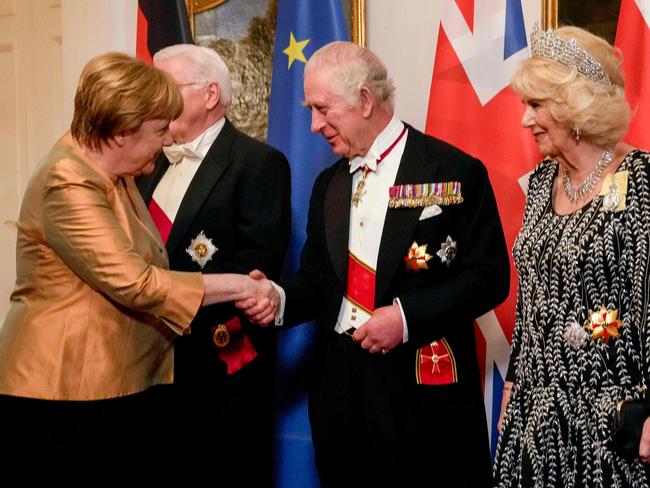 Former German Chancellor Angela Merkel shakes hand with King Charles. Picture: AFP