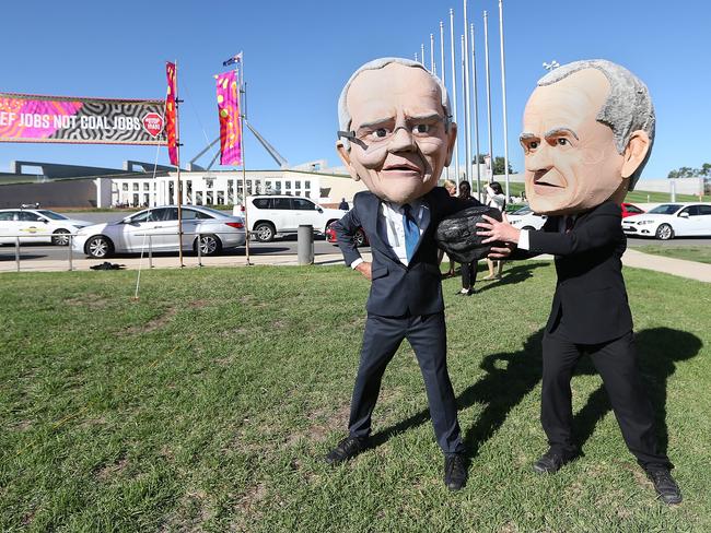 caricatures of PM Scott Morrison and Bill Shorten with people attending a Stop Adani rally on the lawns of Parliament House in Canberra. Picture Kym Smith