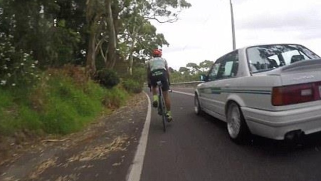 The cyclist claims the car was within touching distance and coming around a blind corner.