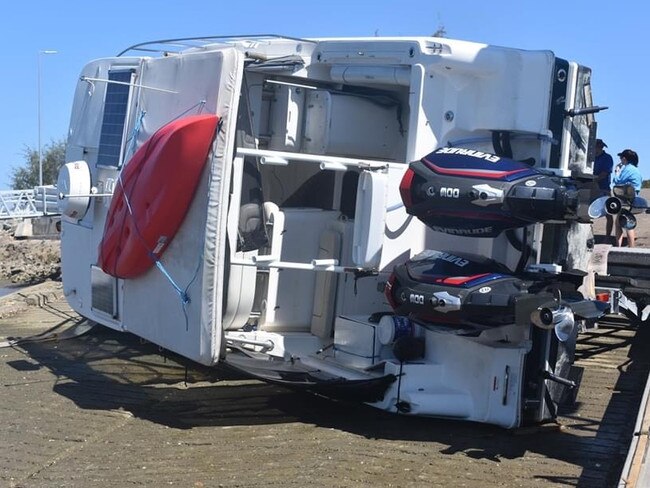 A large boat flipped off its trailer while it was being reversed down a boat ramp at Townsville Recreational Boating Park. Photo: Matt Palmer