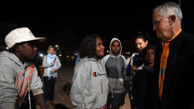 Prime Minister Malcolm Turnbull meets local kids as he rides along in a Julalikari Youth Night Patrol convoy on Sunday night. Picture: AAP/Dan Himbrechts