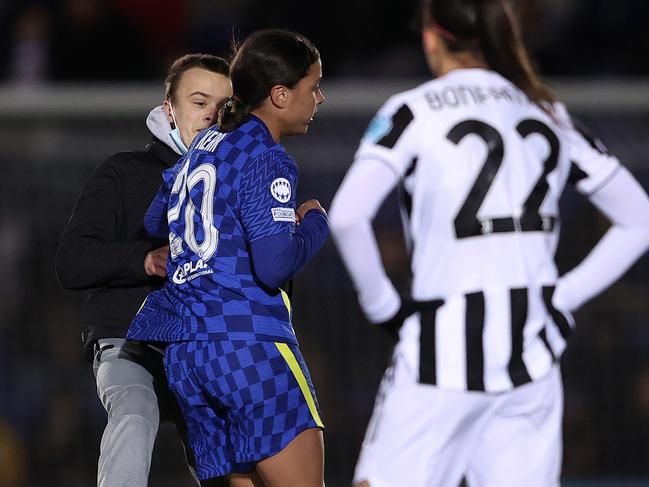 KINGSTON UPON THAMES, ENGLAND - DECEMBER 08: A pitch invader collides with Sam Kerr of Chelsea during the UEFA Women's Champions League group A match between Chelsea FC and Juventus at Kingsmeadow on December 08, 2021 in Kingston upon Thames, England. (Photo by Warren Little/Getty Images)