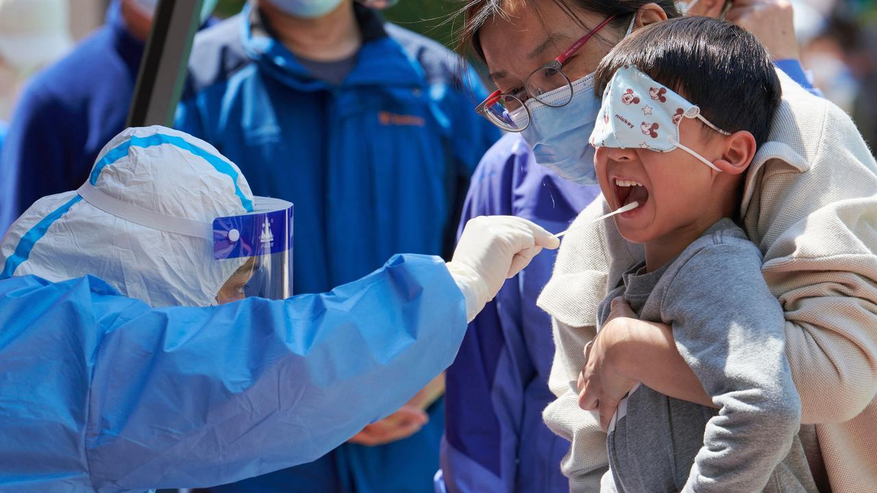 A child receives a swab test for the Covid-19 coronavirus in a compound during a Covid-19 lockdown in Pudong district in Shanghai. Picture: Liu Jin/AFP