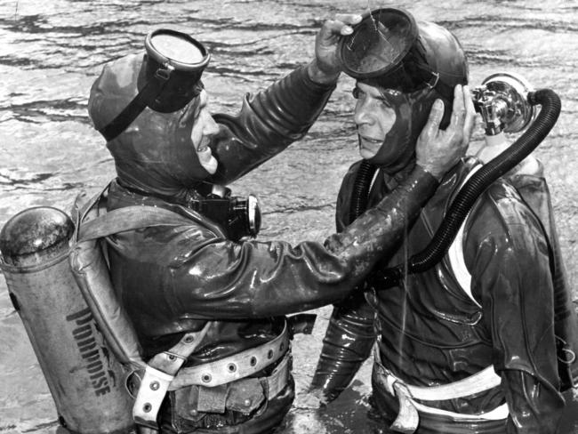 1957: Training for the SA Police Underwater Rescue Squad takes place in a swimming pool, with MTC R.E. McCallum showing MTC B.R. Bald how to adjust his suit and equipment.