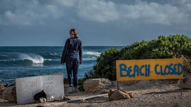 A local woman looks over D'Estrees Bay after a surfer was attacked by a shark today. Picture: Sean McGowan