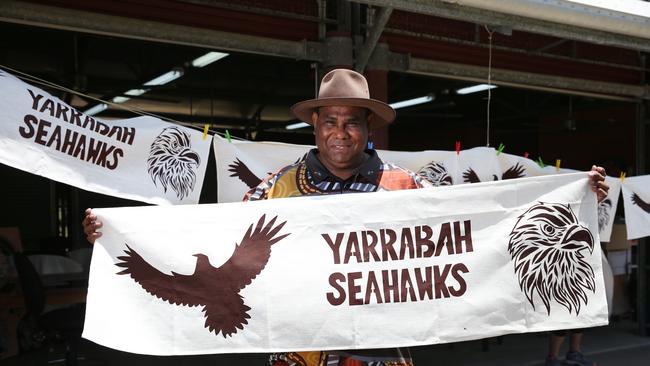 Yarrabah mayor Ross Andrews proudly flies a Seahawks banner at the Yarrabah Arts Centre. Picture: Brendan Radke