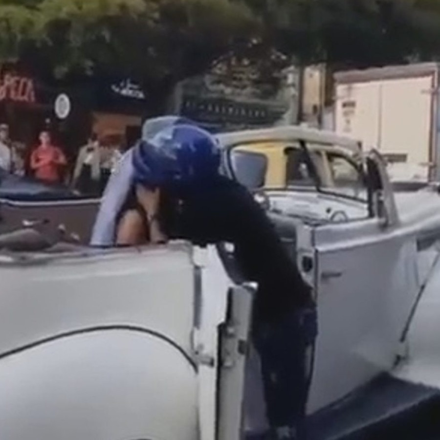 A desperate biker tried to stop his ex-girlfriend from getting married as she headed to the chapel. Here he tries to kiss her. Picture: Central European New