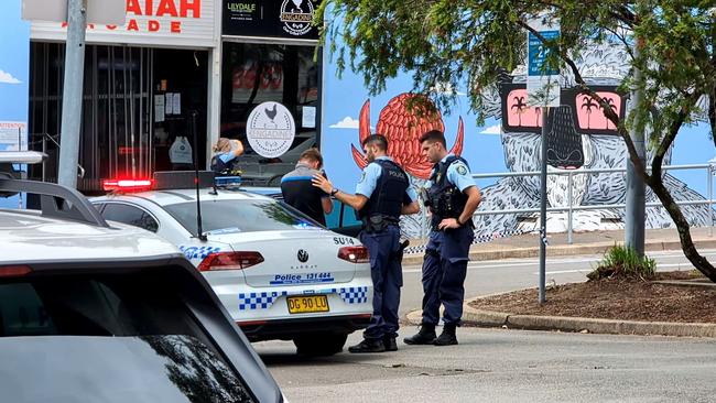 Police comfort a fellow worker at the scene on Tuesday. Picture: TNV