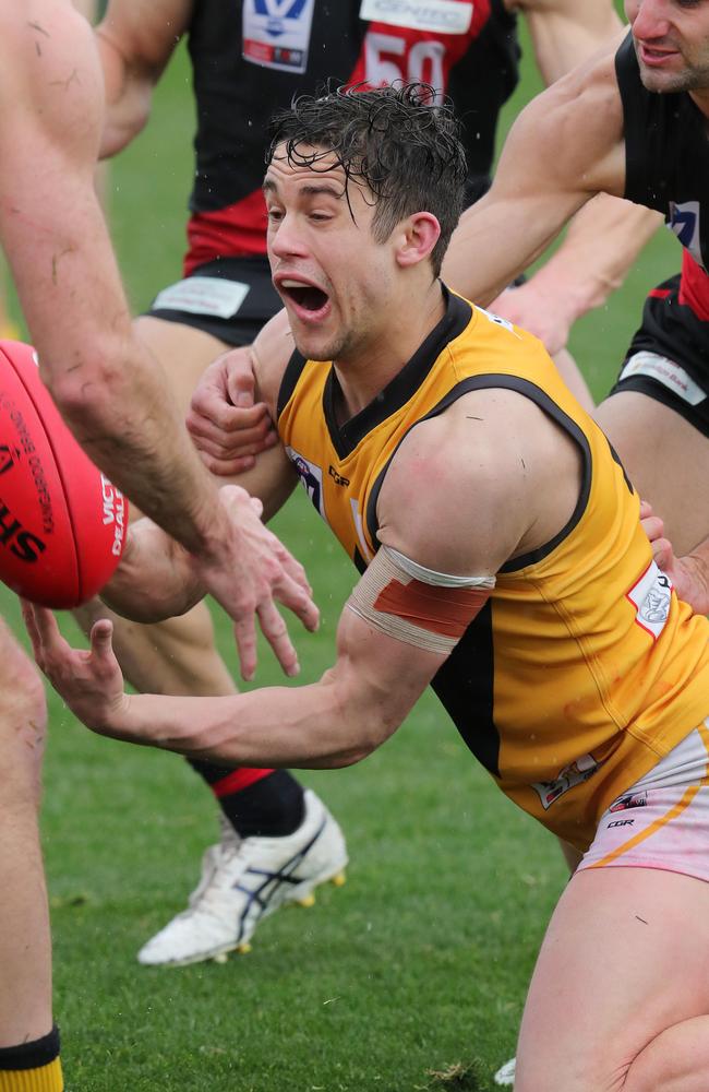 Tommy Gribble shoots out a handball. Pic: Michael Klein.