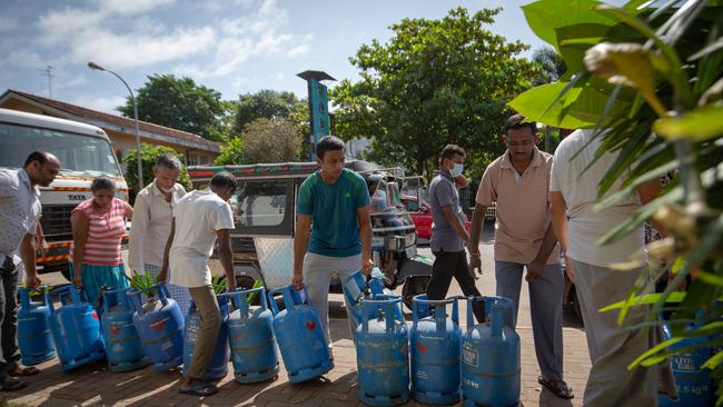 People wait in a queue to buy cooking-gas cylinders on Thursday in Colombo. Picture: Getty Images