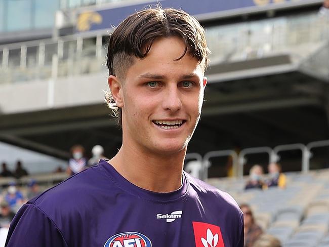 PERTH, AUSTRALIA - APRIL 03: Debutant Neil Erasmus is presented his shirt by Andrew Brayshaw of the Dockers during the 2022 AFL Round 03 match between the West Coast Eagles and the Fremantle Dockers at Optus Stadium on April 03, 2022 In Perth, Australia. (Photo by Will Russell/AFL Photos via Getty Images)