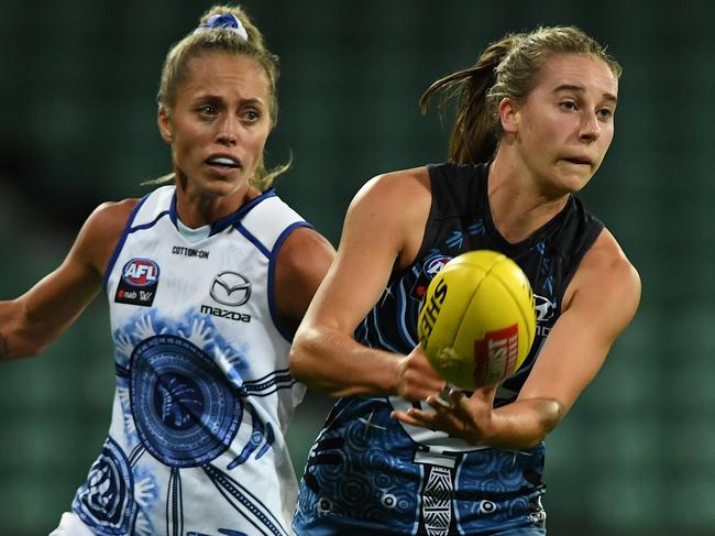 Mimi Hill handballs against North Melbourne in Launceston last month.