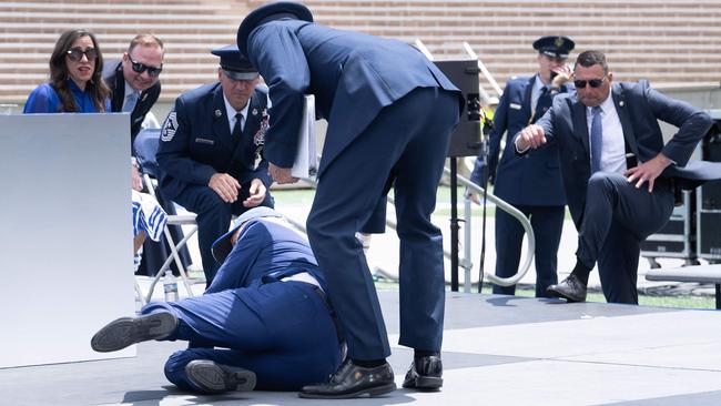 Aides rush to help President Biden after he fell during the graduation ceremony at the United States Air Force Academy on June 1, 2023. Picture: Brendan Smialowski / AFP