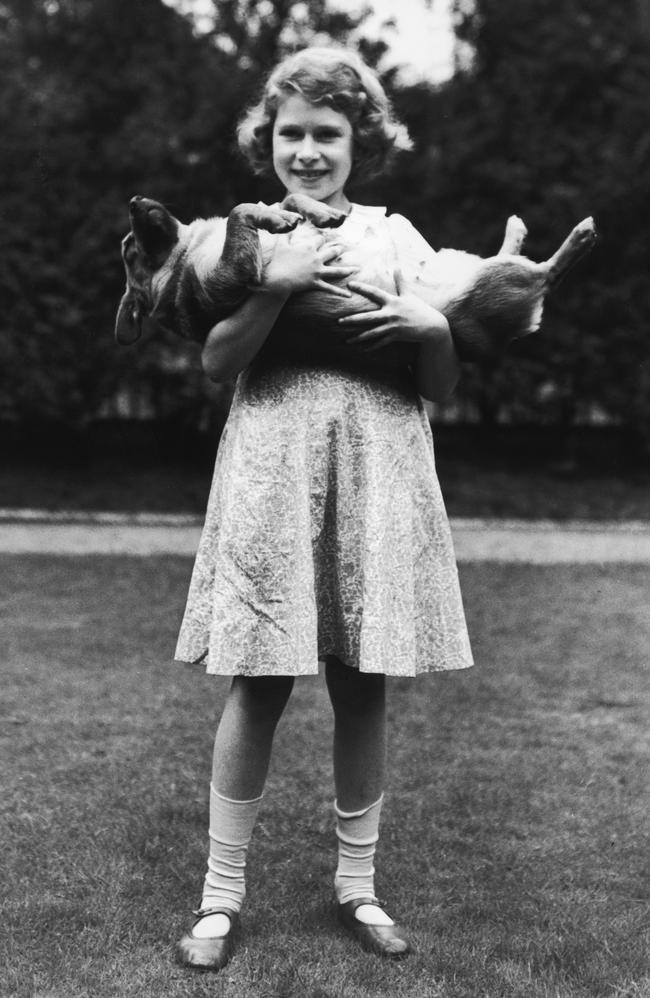 Princess Elizabeth holds one of her many beloved corgis in 1936. Picture: Lisa Sheridan/Getty Images