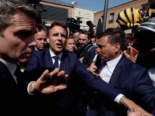 Emmanuel Macron meets Paris residents in April, but was largely absent from the hustings leading up to last Sunday’s parliamentary election. Picture: Benoit Tessier/POOL/AFP