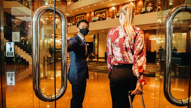 Kazuki Tabata welcomes a guest to the Four Seasons in Sydney, which has benefited from the staycation trend. Picture: Ryan Osland