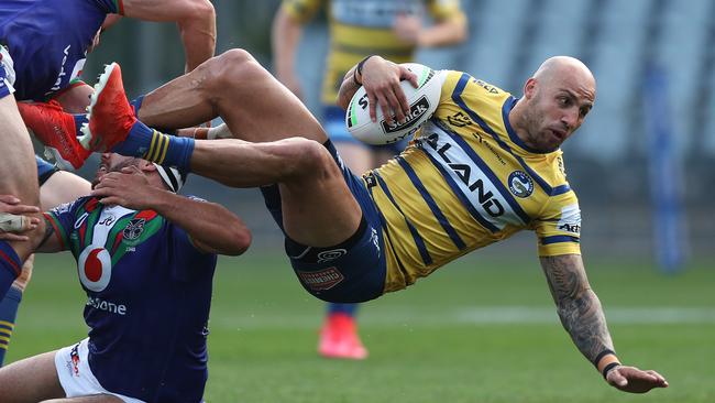 Parramatta's Blake Ferguson gets some air in a tackle. Picture: Brett Costello