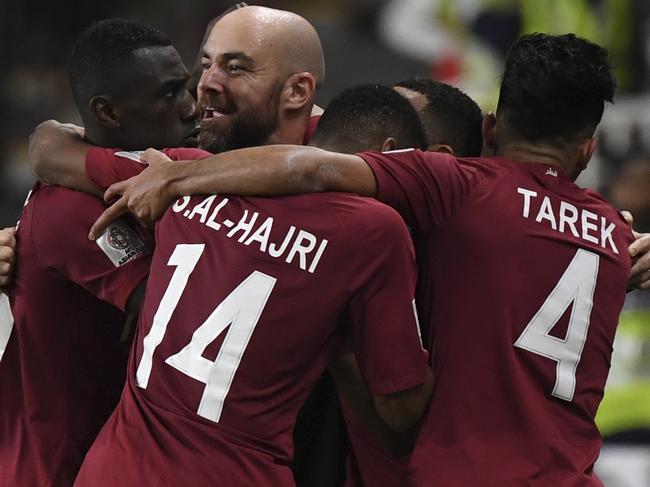 Qatar's head coach Felix Sanchez celebrates with his players after Qatar's defender Hamid Ismail scored his side's fourth goal during the AFC Asian Cup semifinal soccer match between United Arab Emirates and Qatar at Mohammed Bin Zayed Stadium in Abu Dhabi, United Arab Emirates, Tuesday, Jan. 29, 2019. (AP Photo/Hassan Ammar)